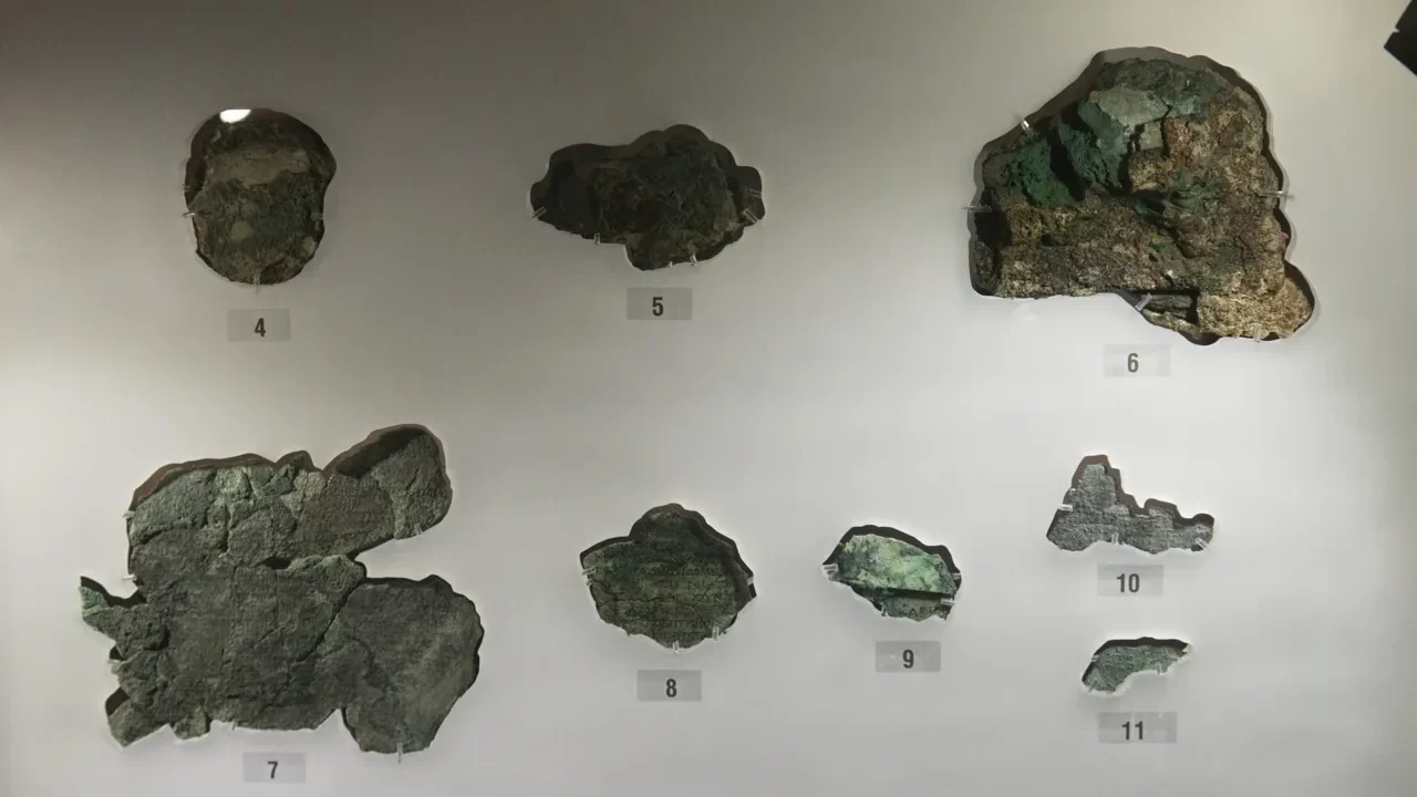 Surviving fragments of the Antikythera mechanism displayed at the National Archaeological Museum in Athens.
