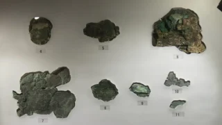 Surviving fragments of the Antikythera mechanism displayed at the National Archaeological Museum in Athens.