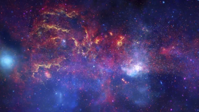 Galactic Center composite combining Hubble, Spitzer, and Chandra observations with assigned colors.