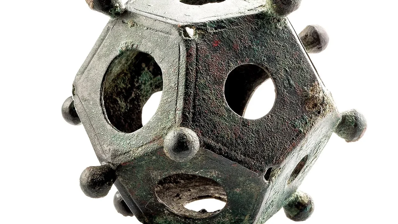 A Roman bronze dodecahedron with openings and corner knobs.