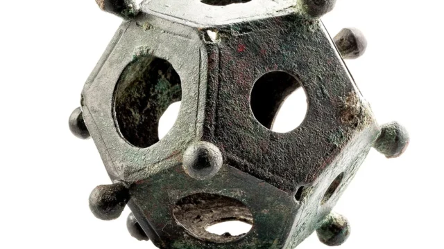 A Roman bronze dodecahedron with openings and corner knobs.