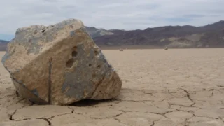 Rock and trail on Racetrack Playa in Death Valley National Park.