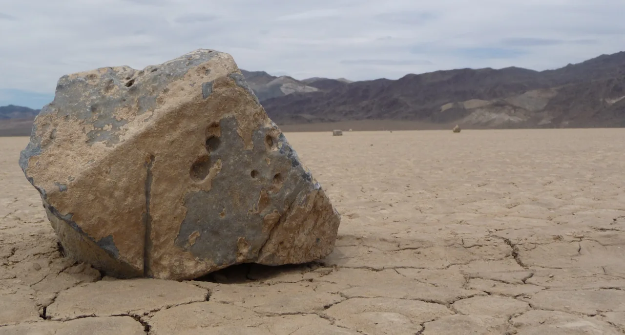 Rock and trail on Racetrack Playa in Death Valley National Park.