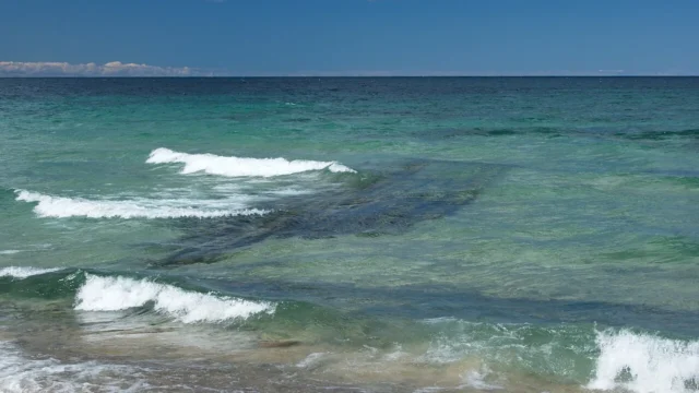 Submerged shipwreck visible from shore. Context photograph, not the newly exposed Warren Sawyer remains.